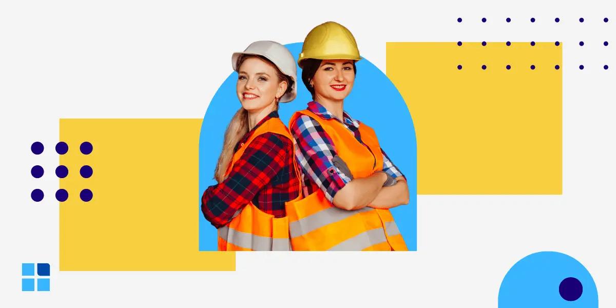 Two female construction workers in hard hats and reflective vests stand back-to-back.