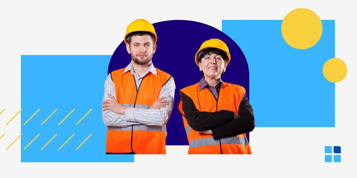 2 construction workers wearing orange safety vests & yellow helmets stand confidently.