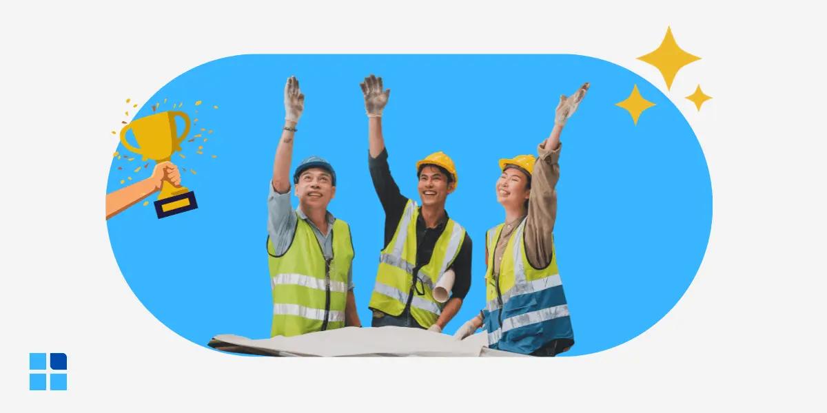 Three construction workers in safety vests and helmets cheerfully raise their arms, celebrating.