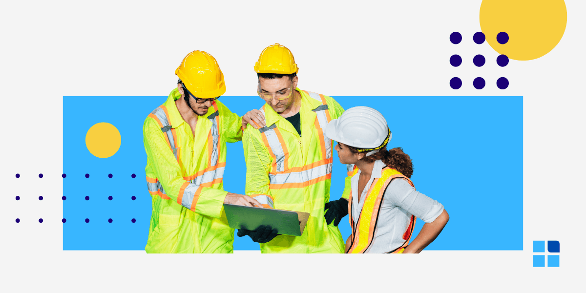 Three construction workers in safety vests and helmets discuss a project using a laptop.