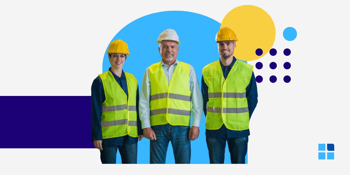 Three construction workers wearing yellow safety vests and hard hats smile confidently.
