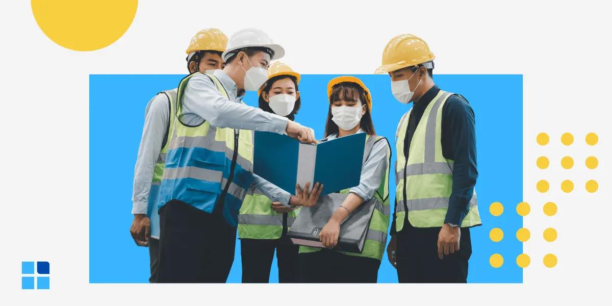 A group of five construction workers wearing hard hats, masks, and reflective vests.