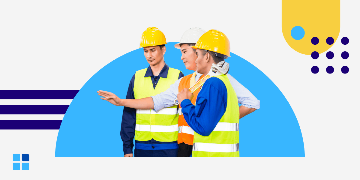 Three construction workers in colorful vests and helmets discuss plans actively.